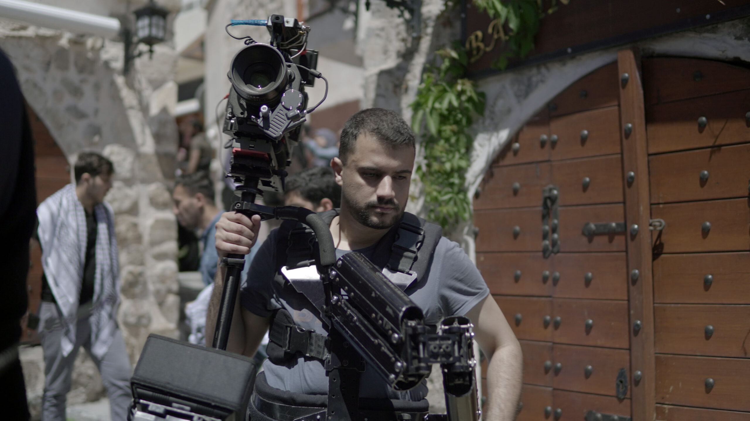 A videographer is holding his equipment
